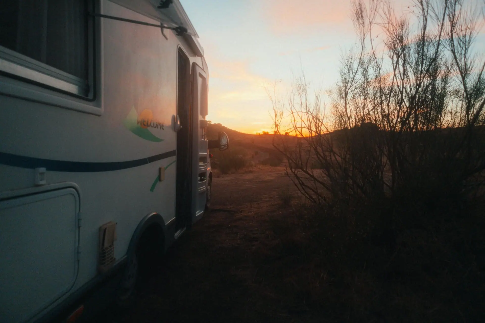 A motorhome parked in the outback at golden hour